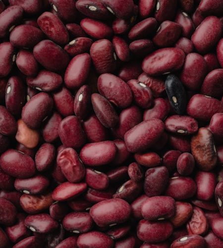 A detailed close-up of red kidney beans, showcasing texture and color. Perfect for food and agriculture themes.